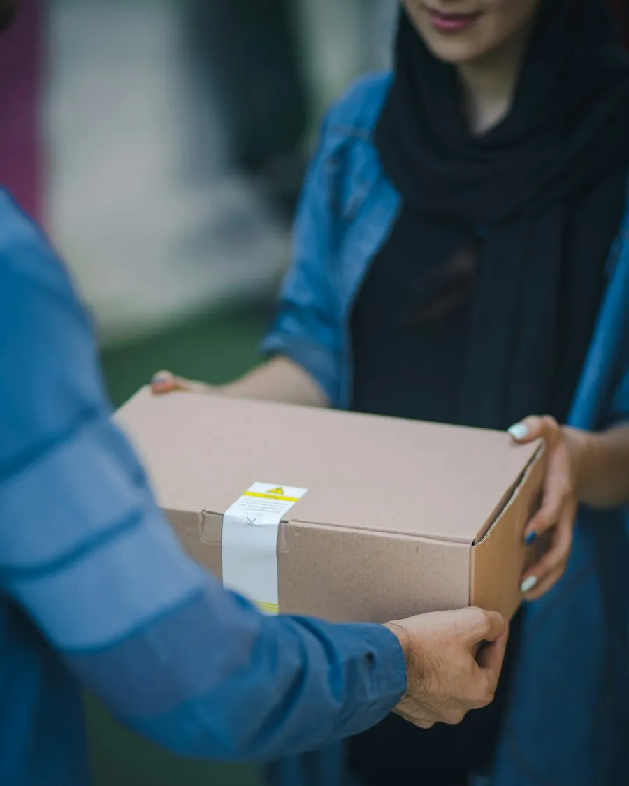 Person carrying a cardboard box